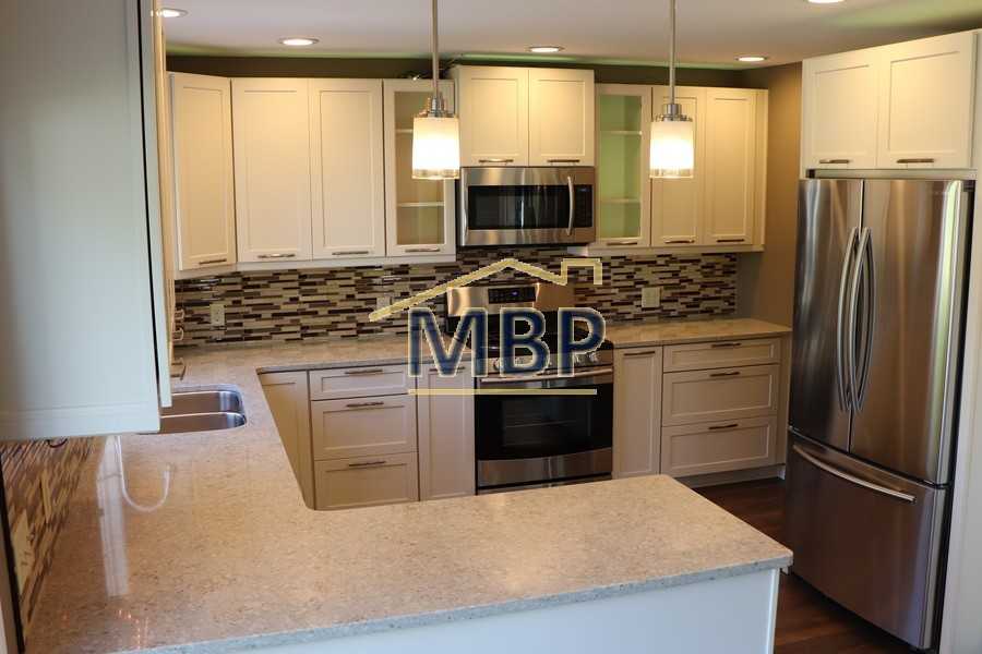 Kitchen- completely replaced with maple cabinets, quartz countertops and SS appliances
