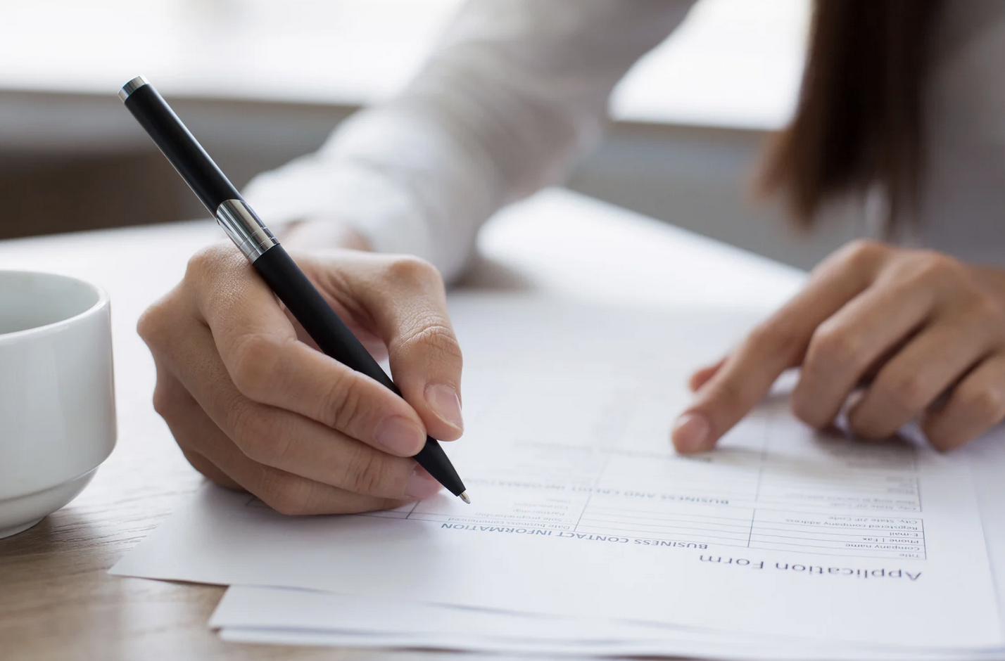 Photo of a person completing a paper form.